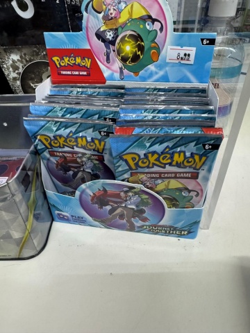 Single Pokémon cards sold at the register at Olympia Market.