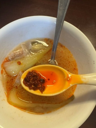 Sinigang with a swirl of chili oil on top
